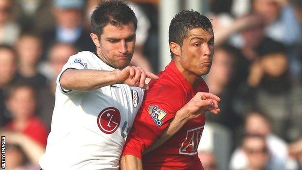 Hughes tussles with Ronaldo in a 2009 Premier League game