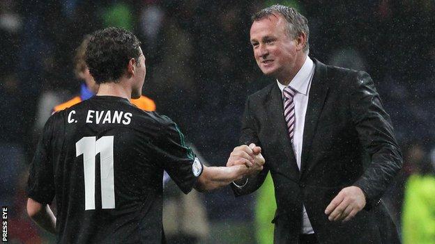 Michael O'Neill celebrates with Corry Evans after the final whistle in Porto