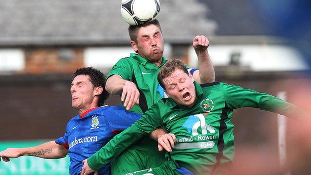 Mark Stafford (centre) and Mark McConkey in aerial action against Linfield's Daryl Fordyce