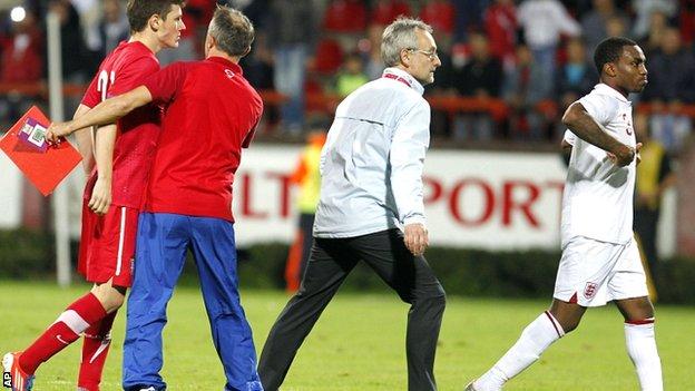 Danny Rose (right) leaves the field after being sent-off against Serbia U-21