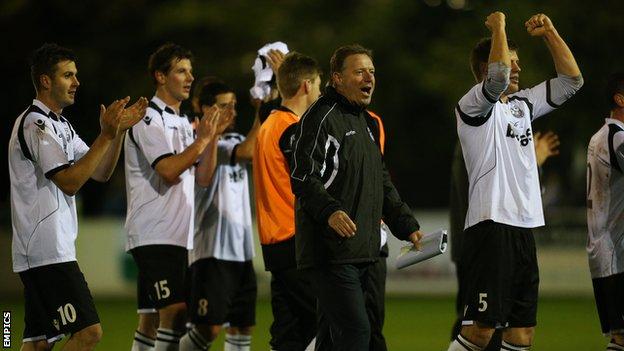 Cambridge City's management and players celebrate