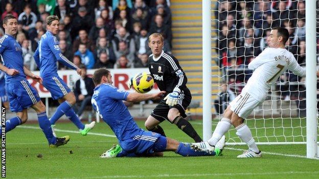 Leon Britton clears off the Swansea goal-line