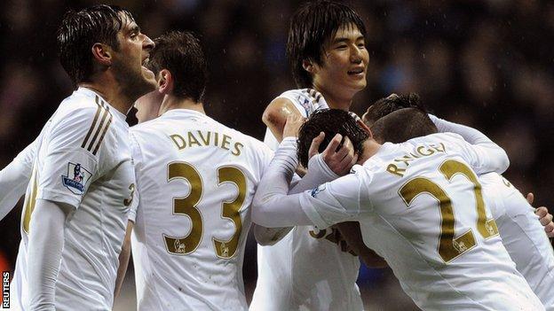 Swansea celebrate their late equaliser against Chelsea