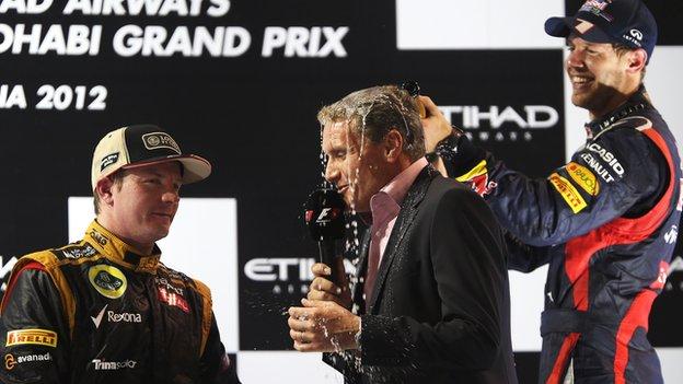 David Coulthard is drenched by Sebastian Vettel while interviewing Kimi Raikkonen (left).