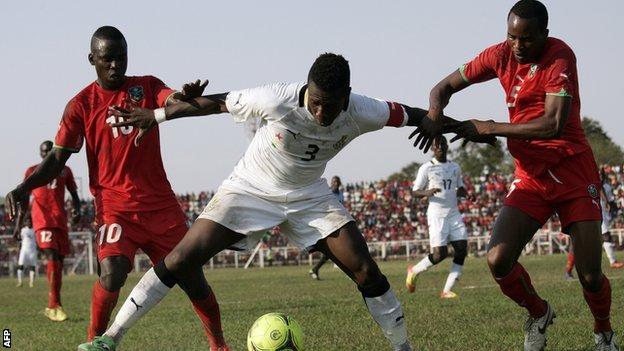 Malawi players in action with Ghana