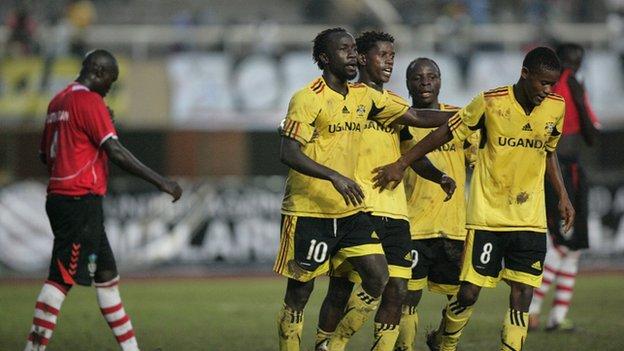 Ugandan players celebrate scoring against Kenya