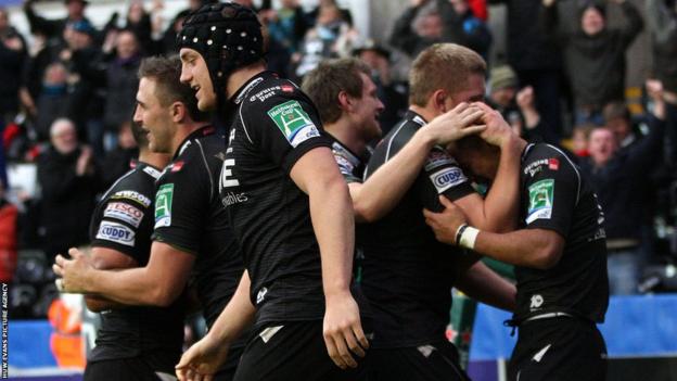 Try-scorer Walker is congratulated by his team-mates and the Ospreys go on to record a notable 17-6 win over Toulouse to keep their Heineken Cup hopes alive