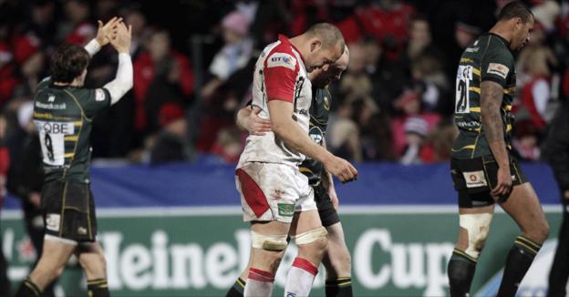 Dan Tuohy shows his disappointment as he leaves the field after the game while Northampton players celebrate
