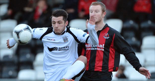 Jordan Hughes and Davy Magowan battle for the ball during the Premiership game at Seaview
