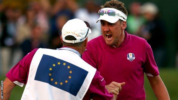 Ian Poulter celebrates with his caddy