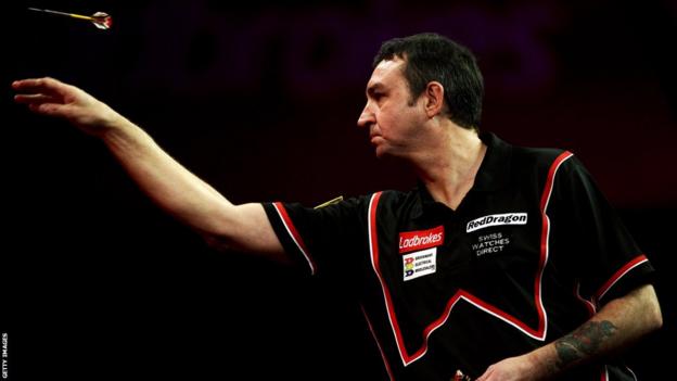 Richie Burnett goes out of the World Darts Championship at the Alexandra Palace, beaten 4-1 by England's Andy Hamilton