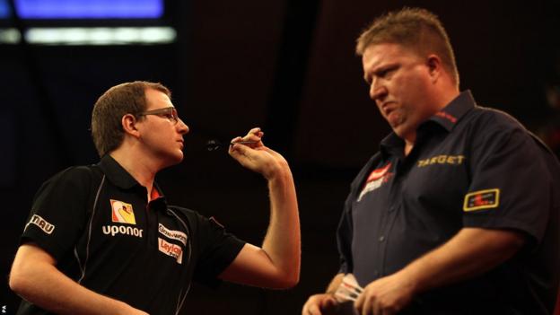 There is no better luck for Mark Webster (left), who bows out of Alexandra Palace after losing 4-2 to Colin Lloyd in the second round of the World Darts Championship