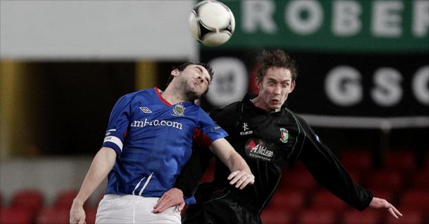Michael Gault and David Howland in aerial action at Windsor Park on Boxing Day