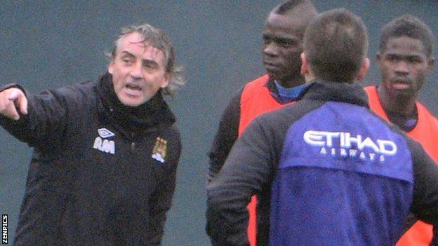 Roberto Mancini (far left) and Mario Balotelli (second from left)