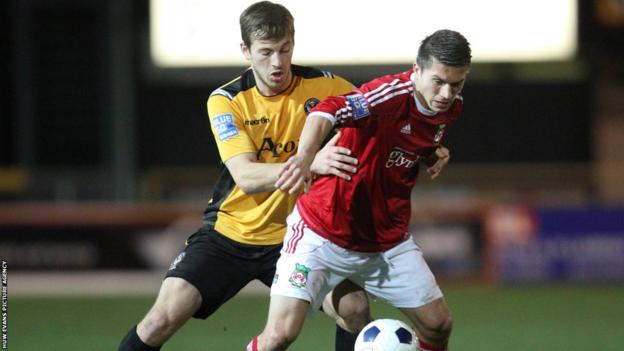 Max Porter and Wrexham's Adrian Cieslewicz battle for the ball