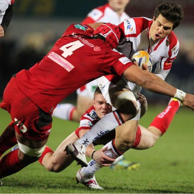 Ulster full-back Adam D'Arcy is tackled by Sione Timani and Tavis Knoyle of Scarlets
