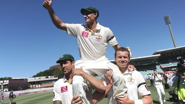 Australian cricketer Michael Hussey (C) is carried off the field by Peter Siddle (R) and Mitchell Johnson (L) after defeating Sri Lanka