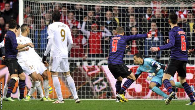 Arsenal forward Lukas Podolski equalises against Swansea