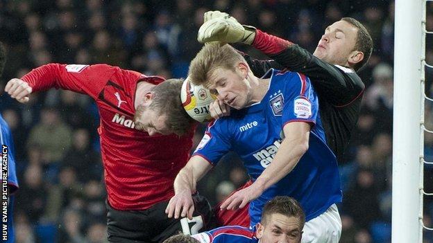 Cardiff City's Aron Gunnarsson has a header blocked by the Ipswich defence