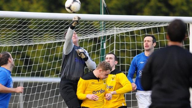 H&W Welders keeper Mark Miskelly punches clear in the Mourneview Park tie against Glenavon