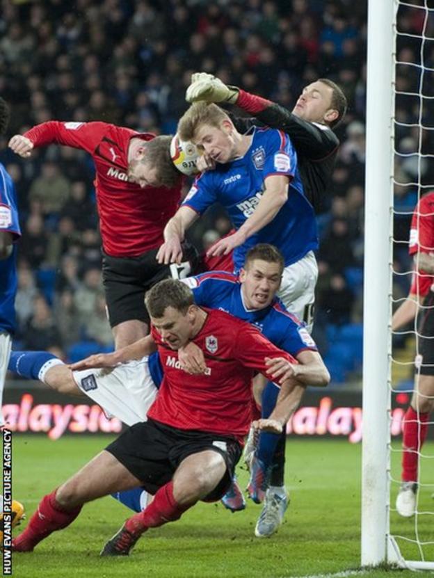 Cardiff City's Aaron Gunnarsson and Ben Turner challenge for a corner against Ipswich Town at Cardiff City Stadium