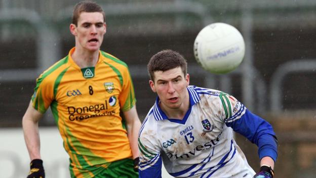 Caolan Ward of Donegal looks on as Monaghan player Keith McEneaney keeps his focus on the ball at Ballybofey
