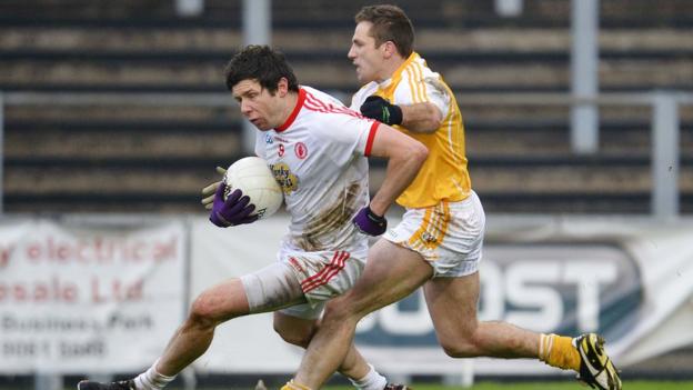 Sean Cavanagh attempts to get away from Antrim opponent Tony Scullion during Tyrone's 2-13 to 1-07 win at Casement Park
