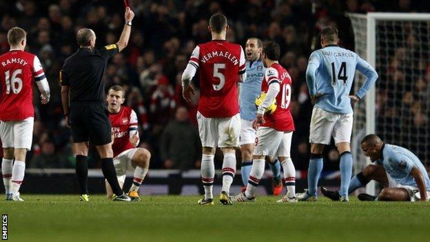 Vincent Kompany (right, on ground) is sent off against Arsenal