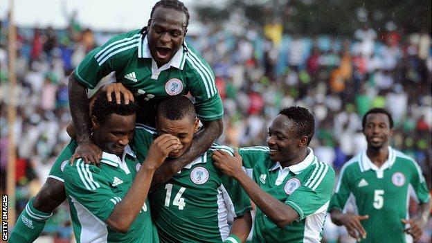 Nigeria's John Obi Mikel (L) celebrates with teammates