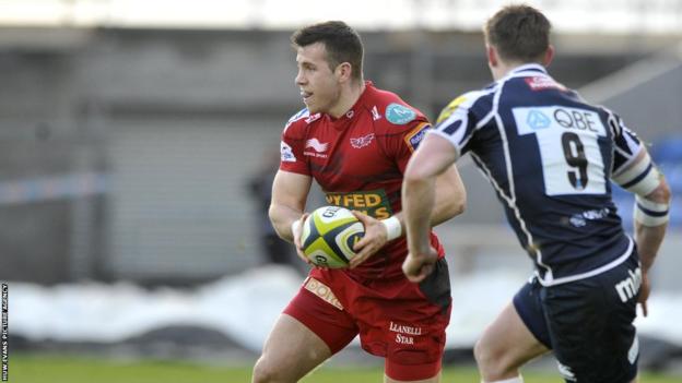 Scarlets scrum-half Gareth Davies looks for a pass during the LV= Cup match against Sale.