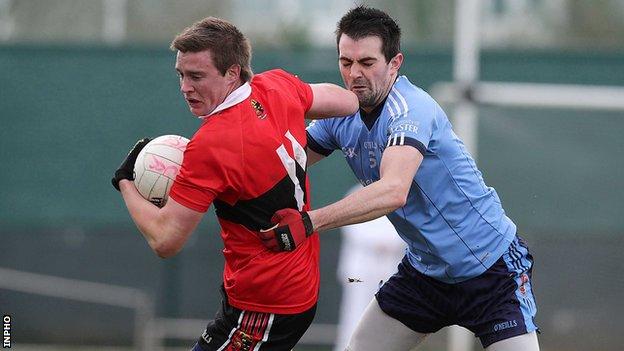 UUJ's Gerard McCartan tries to get a challenge in on UCC's Brian Coughlan
