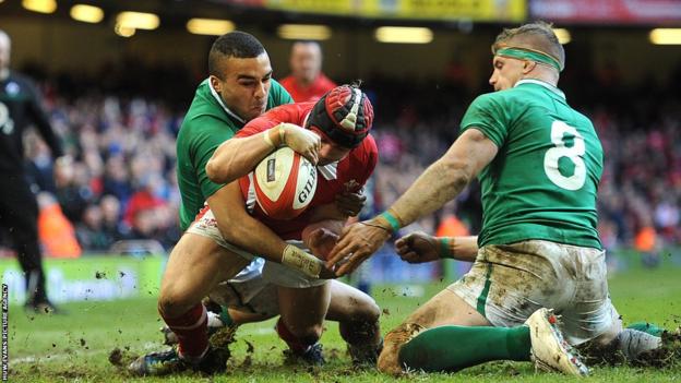 Leigh Halfpenny wriggles over in the corner as Wales begin a fight-back against Ireland