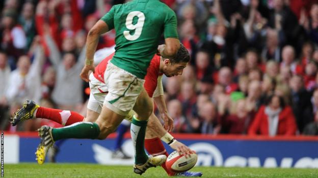 Wing Alex Cuthbert scythes through to add a second Wales try against Ireland