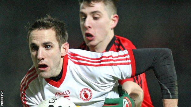 Tyrone's Mark Donnelly attempts to burst away from Ryan Boyle