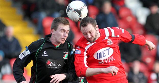 Jay Magee and Tim Mouncey in aerial action during Glentoran's win over Portadown