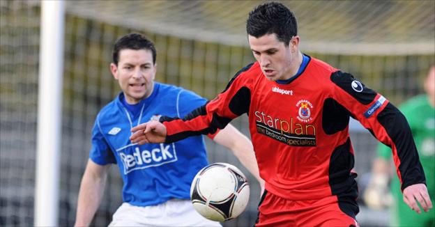 Glenavon defender Eddie McCallion keeps an eye on Dungannon's PJ Lavery at Mourneview Park