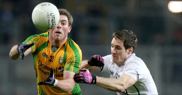 Donegal's Dermot Molloy distributes the ball as Kildare's Gary White closes in