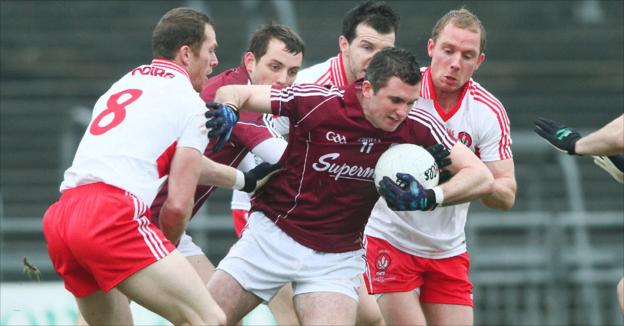 Michael Martin attempts to make a break for Galway as Patsy Bradley leads a clutch of Derry players in pursuit