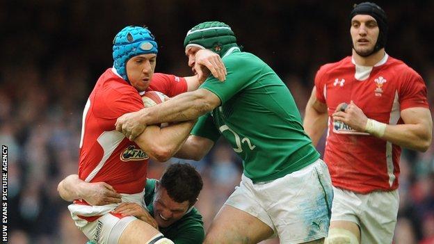 Justin Tipuric is stopped by Ireland tacklers as fellow Wales back-row Sam Warburton looks on