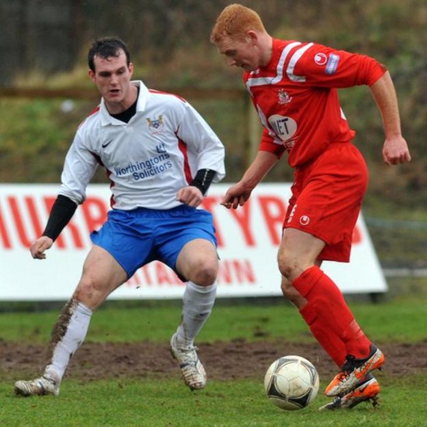 Ards defender Gary Spence moves in to challenge Joe McNeill of Portadown in the Irish Cup tie at Shamrock Park