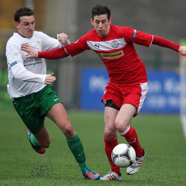 Stephen O'Neill of Donegal Celtic challenges Cliftonville opponent Eamonn Seydak during the Irish Cup tie at Solitude