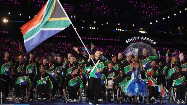 Oscar Pistorius carrying the South African flag at 2012 Paralympics in London.