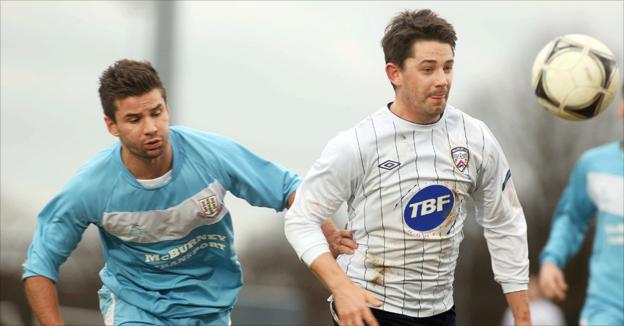 Ballymena's Mark McCullagh closes in on Coleraine striker Curtis Allen at the Showgrounds