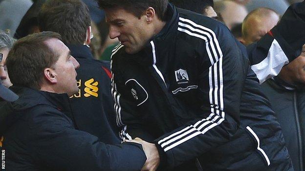 Manager Michael Laudrup (right) congratulates Liverpool boss Brendan Rodgers, his predecessor at Swansea, after the 5-0 loss at Anfield