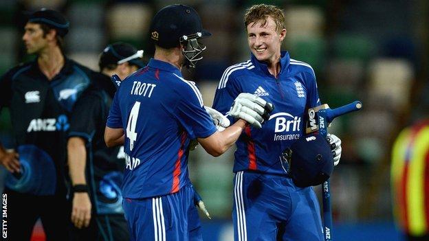 Joe Root (right) is congratulated by Jonathan Trott