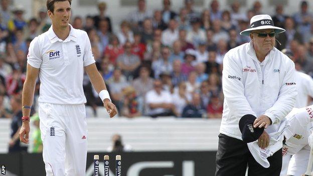 Umpire Steve Davis signals a dead ball after Steven Finn knocks over the stumps in his delivery stride