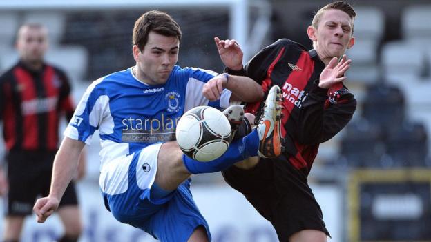 Dungannon's Ryan O'Neill and Matthew Snoddy of Crusaders battle for the ball at Seaview