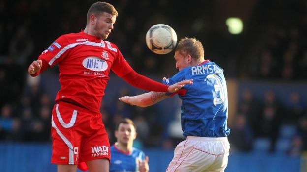 Portadown striker Darren Murray and Linfield defender David Armstrong in aerial action at Windsor Park