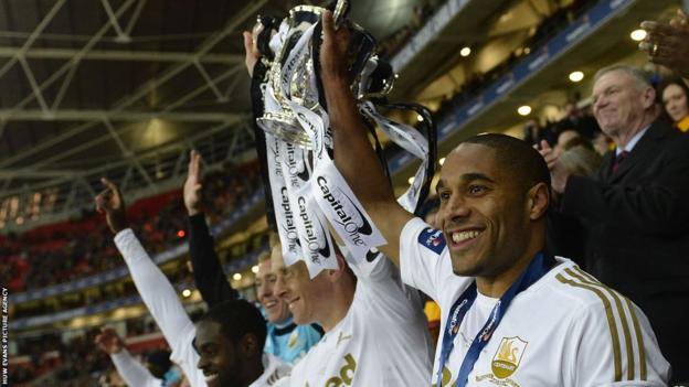 Captains Ashley Williams and Garry Monk lift the Capital One Cup together after Swansea City's record 5-0 win over Bradford City at Wembley