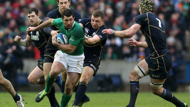 Rob Kearney is tackled by Scotland's Tim Visser, Duncan Weir and Kelly Brown
